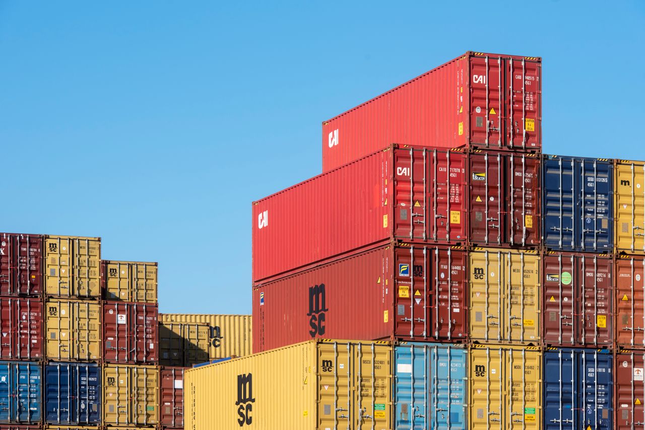 The Art of Drawing Readers In: Your attractive post title goes here A vibrant collection of stacked shipping containers under a clear, blue sky. Ideal for logistic themes.